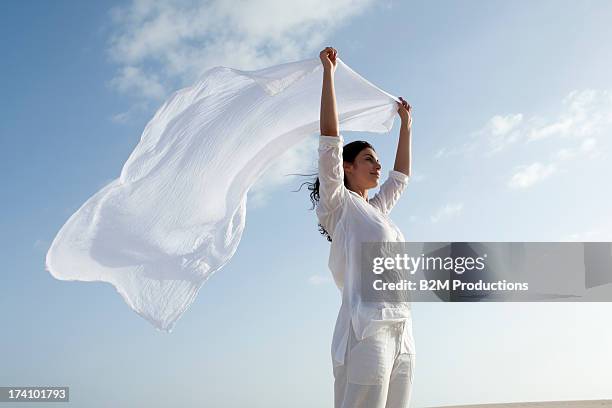 young happy woman holding scarf - white scarf stock pictures, royalty-free photos & images