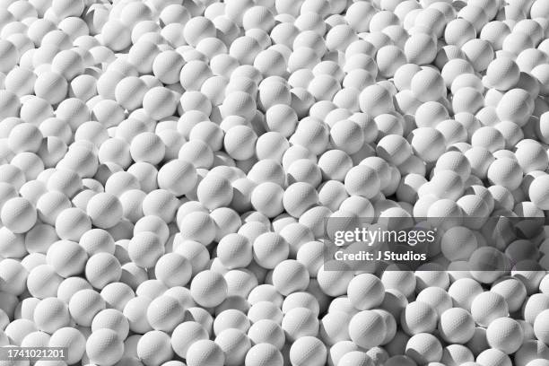 close-up of a lot of golf balls - sports equipment pile stock pictures, royalty-free photos & images