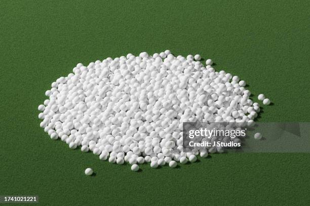 large pile of golf balls on green grass - golf balls stock pictures, royalty-free photos & images