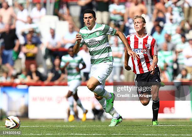 Tom Rogic of Celtic competes for the ball with George Saville of Brentford during a pre season friendly match between Brentford and Celtic at Griffin...