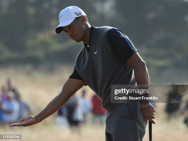 Tiger Woods of the United States reacts to a putt on the 16th hole during the third round of the 142nd Open Championship at Muirfield on July 20,...