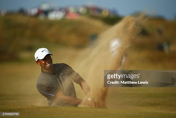 Tiger Woods of the United States plays out of a bunker on the 15th hole during the third round of the 142nd Open Championship at Muirfield on July...