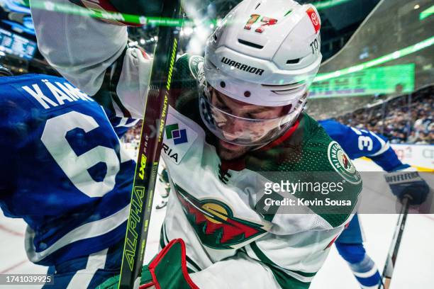 Marcus Foligno of the Minnesota Wild battles against David Kampf of the Toronto Maple Leafs during the third period at the Scotiabank Arena on...
