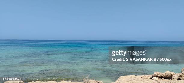 scenic view of sea against clear sky,oman - oman foto e immagini stock