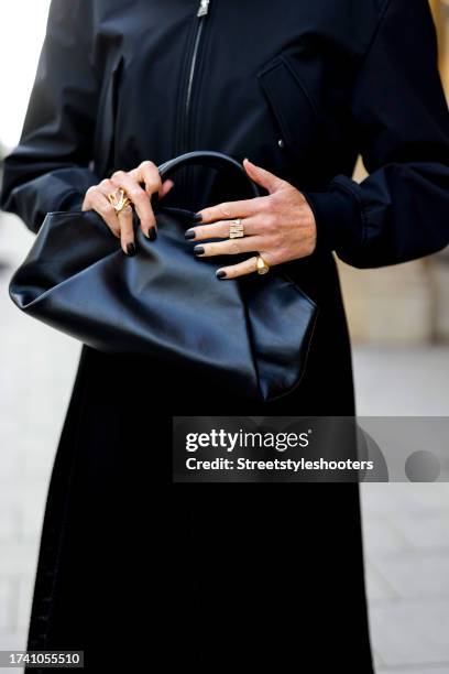 Influencer Annette Weber, wearing a black skirt by Max Mara, a black blouson by COS and a black bag by COS, during a streetstyle shooting on October...