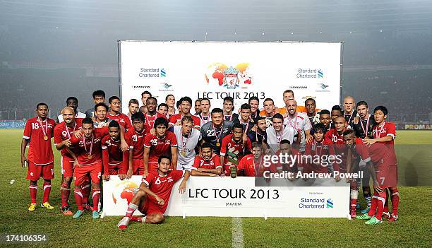 The Liverpool squad lift the Standard Chartered cup at the Pre Season match between Indonesia XI and Liverpool at Gelora Bug Karno stadium on July...