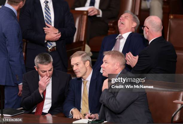 Rep. Jim Jordan talks to a staff member and Rep. Warren Davidson while former Speaker of the House Kevin McCarthy laughs, as the House of...