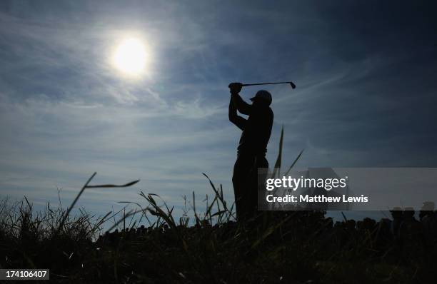 Tiger Woods of the United States hits a shot on the 15th during the third round of the 142nd Open Championship at Muirfield on July 20, 2013 in...