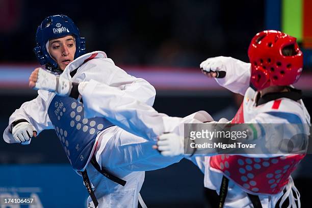 Sousan Hajipourgoli of Iran competes with Dilobar Saydullaeva of Uzbekistan during a women's -57 kg combat of WTF World Taekwondo Championships 2013...