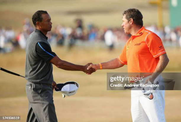 Tiger Woods of the United States shakes hands with Lee Westwood of England after finishing the third round of the 142nd Open Championship at...