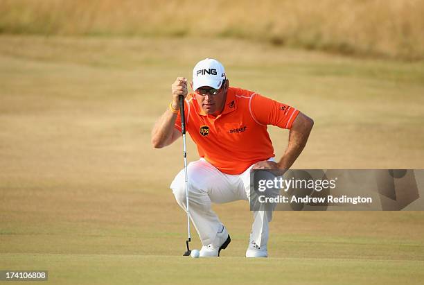 Lee Westwood of England lines up a putt on the 18th green during the third round of the 142nd Open Championship at Muirfield on July 20, 2013 in...