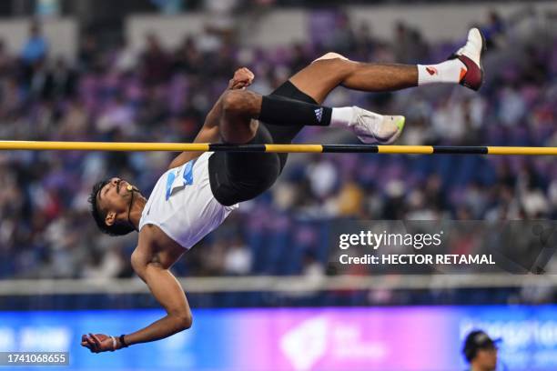 India's Unni Renu competes in the men's high jump-T64 final at the Huanglong Sport Centre Stadium during the 2022 Asian Para Games in Hangzhou in...