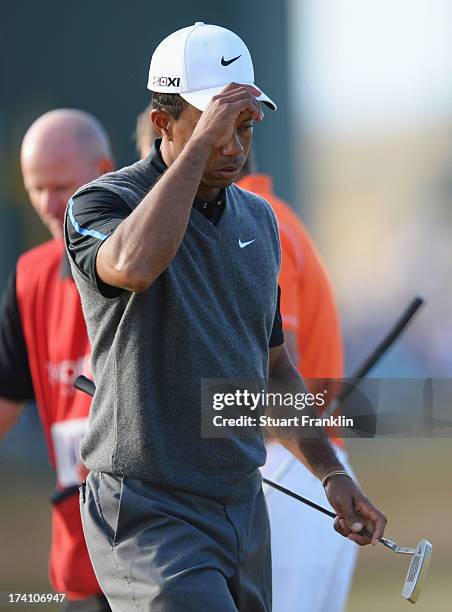 Tiger Woods of the United States reacts as he walks off the 18th after finishing the third round of the 142nd Open Championship at Muirfield on July...