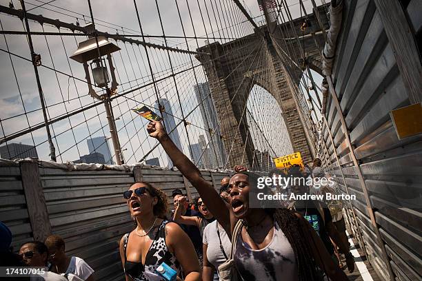 Protestors in support of Trayvon Martin march across the Brooklyn Bridge after attending a rally organized by the Reverand Al Sharpton in response to...
