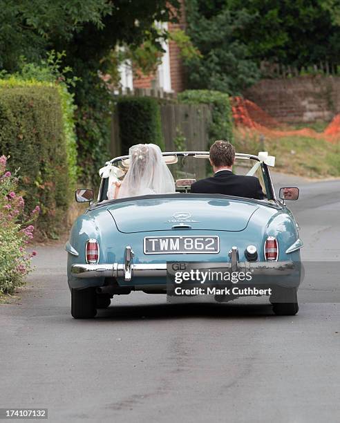 Alicia Fox-Pitt and Sebastian Stoddart drive away after getting married at the Holy Cross church in Goodnestone on July 20, 2013 in Dover, England.