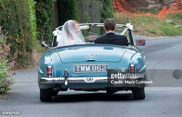 Alicia Fox-Pitt and Sebastian Stoddart drive away after getting married at the Holy Cross church in Goodnestone on July 20, 2013 in Dover, England.