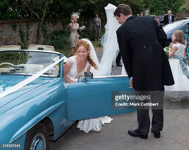 Sebastian Stoddart helps Alicia Fox-Pitt into a car before they drive off after getting married at the Holy Cross church in Goodnestone on July 20,...