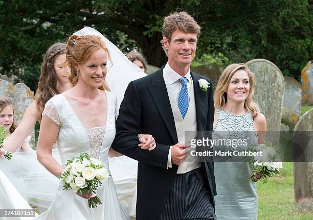 William Fox-Pitt escorts his sister Alicia Fox-Pitt to her wedding to Sebastian Stoddart at the Holy Cross church in Goodnestone on July 20, 2013 in...