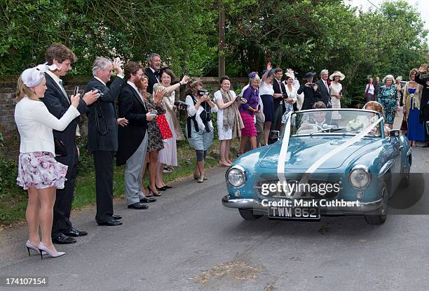 Alicia Fox-Pitt and Sebastian Stoddart drive away after getting married at the Holy Cross church in Goodnestone on July 20, 2013 in Dover, England.