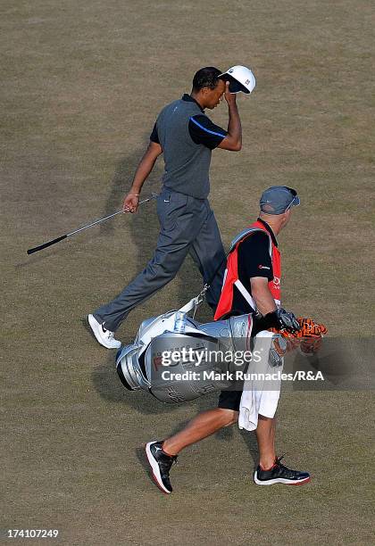 Tiger Woods of the United States walks with his caddie Joe LaCava during the third round of the 142nd Open Championship at Muirfield on July 20, 2013...