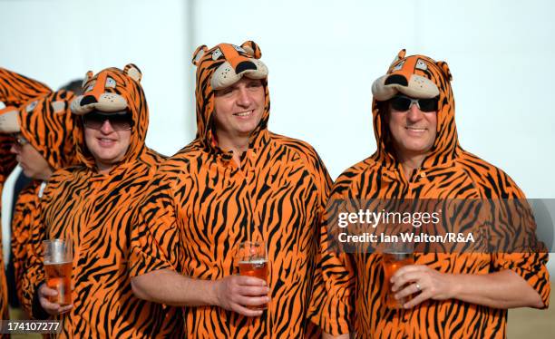 Golf fans in tiger costumes watch the action during the third round of the 142nd Open Championship at Muirfield on July 20, 2013 in Gullane, Scotland.