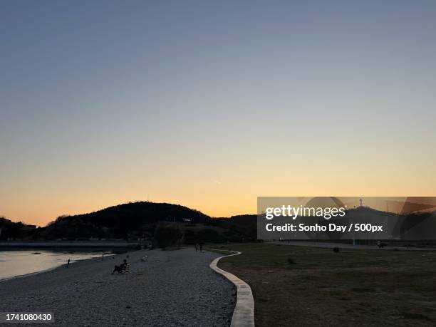 scenic view of beach against clear sky during sunset,china - sonho stockfoto's en -beelden