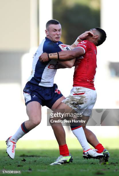 Harry Newman of England is challenged by Isaiya Katoa of Tonga during the Autumn Test Series match between England and Tonga at Totally Wicked...