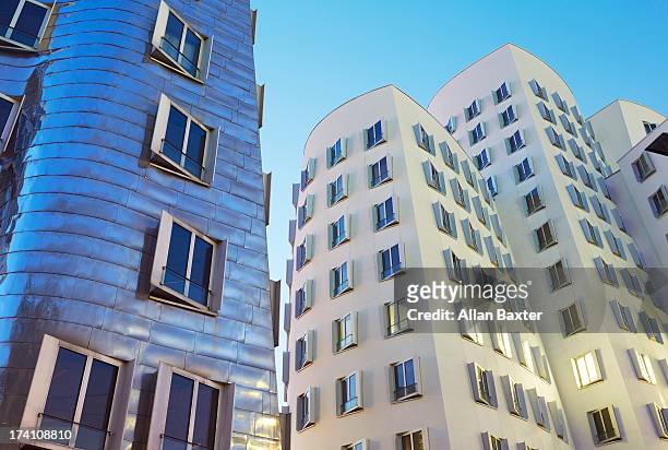 frank gehry's neuer zollhof building at dusk - north rhine westphalia stock pictures, royalty-free photos & images