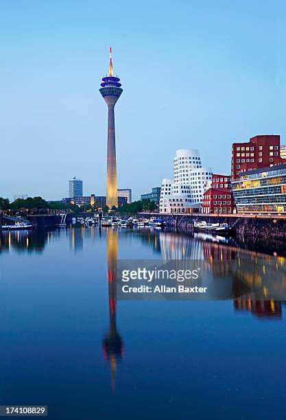 rheinturm communications tower at dusk - düsseldorf medienhafen stock pictures, royalty-free photos & images