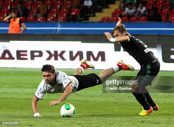 Dmitri Yatchenko of FC Terek Grozny is challenged by Makhach Gadzhiev of FC Amkar Perm during the Russian Premier League match between FC Terek...