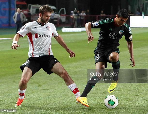 Ailton of FC Terek Grozny is challenged by Makhach Gadzhiev of FC Amkar Perm during the Russian Premier League match between FC Terek Grozny and FC...