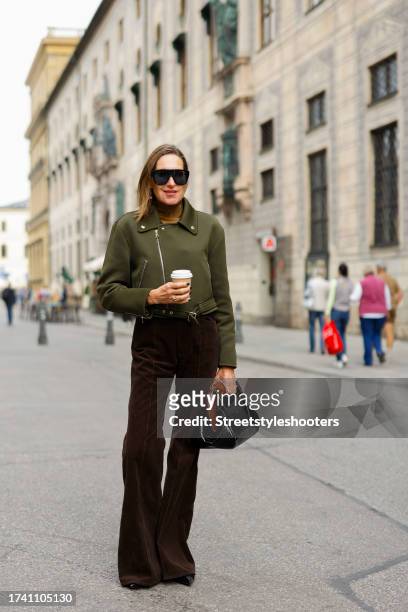 Influencer Annette Weber, wearing dark brown cord pants by Polo Ralph Lauren, a green jacket by Max Mara, black pumps by Chanel, a black bag by Max...