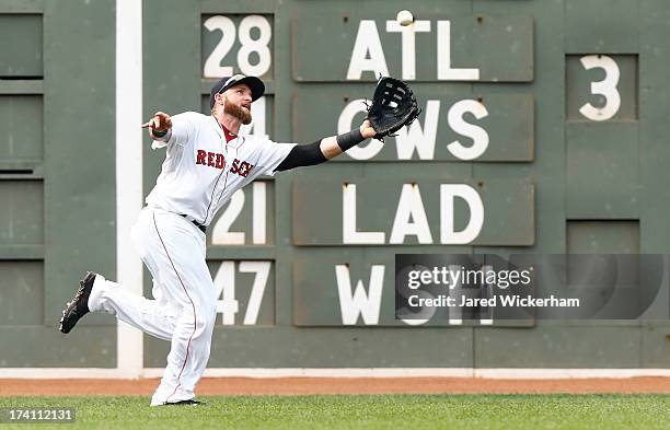 Jonny Gomes of the Boston Red Sox makes a catch in left field against the New York Yankees during the game on July 20, 2013 at Fenway Park in Boston,...