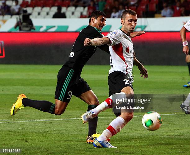 Ailton of FC Terek Grozny is challenged by Ivan Cherenchikov of FC Amkar Perm during the Russian Premier League match between FC Terek Grozny and FC...