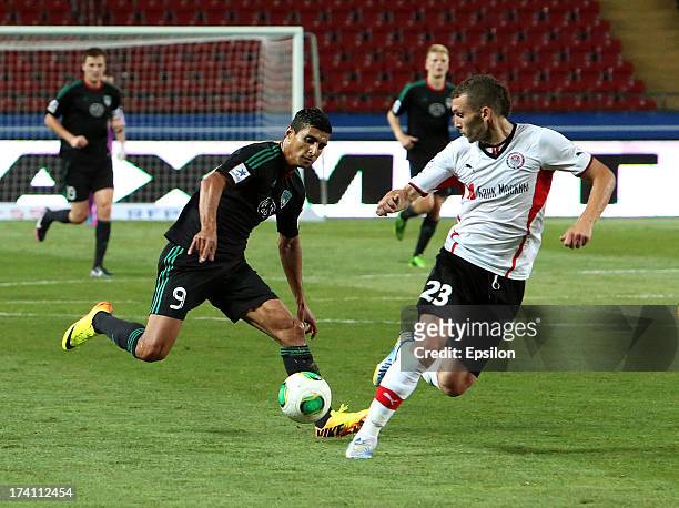 Ailton of FC Terek Grozny is challenged by Ivan Cherenchikov of FC Amkar Perm during the Russian Premier League match between FC Terek Grozny and FC...