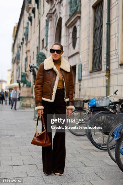 Influencer Annette Weber, wearing dark brown cord pants by Polo Ralph Lauren, a brown lambskin jacket by Polo Ralph Lauren, a beige pullover by Max...