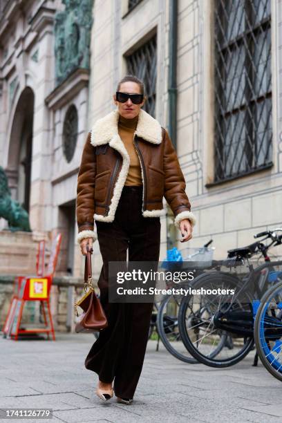 Influencer Annette Weber, wearing dark brown cord pants by Polo Ralph Lauren, a brown lambskin jacket by Polo Ralph Lauren, a beige pullover by Max...