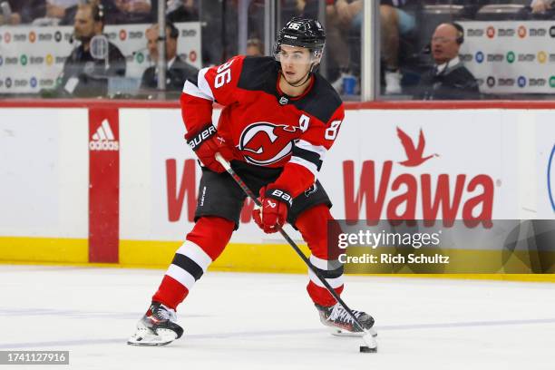 Jack Hughes of the New Jersey Devils in action against the Florida Panthers during a game at Prudential Center on October 16, 2023 in Newark, New...