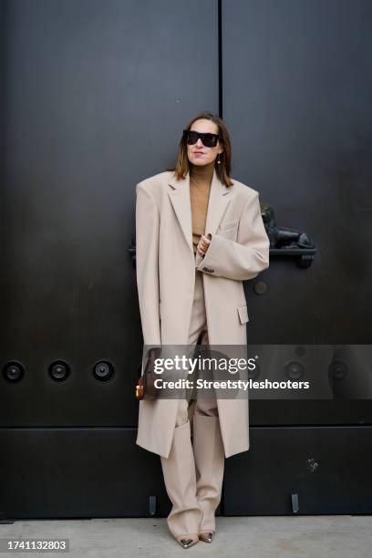 Influencer Annette Weber, wearing a beige coat by Sportmax, beige pants by Sportmax, a beige pullover by Max Mara, a brown bag by Celine, beige pumps...