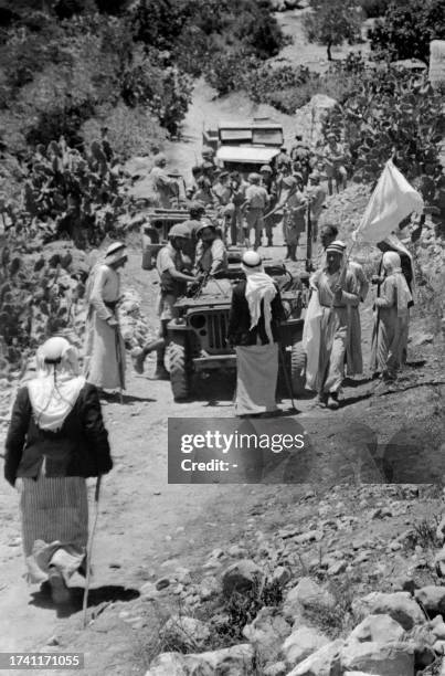 Picture released on September 15, 1948 shows Palestinians villagers holding a white flag as they surrendered during the 1948 Arab war against the...