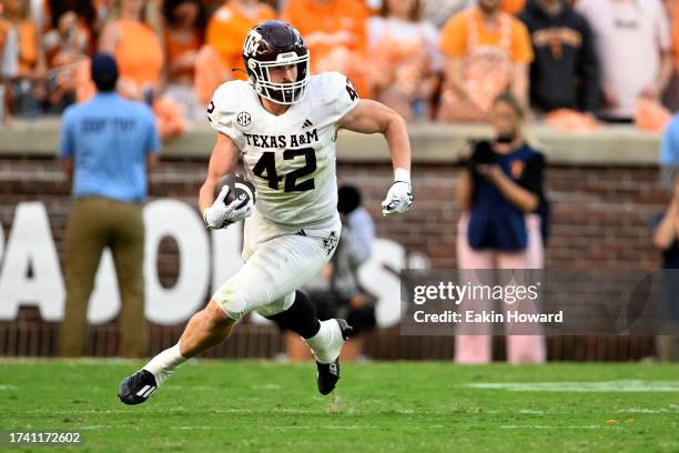 Max Wright of the Texas A&M Aggies runs the ball against the Tennessee Volunteers in the third quarter at Neyland Stadium on October 14, 2023 in...