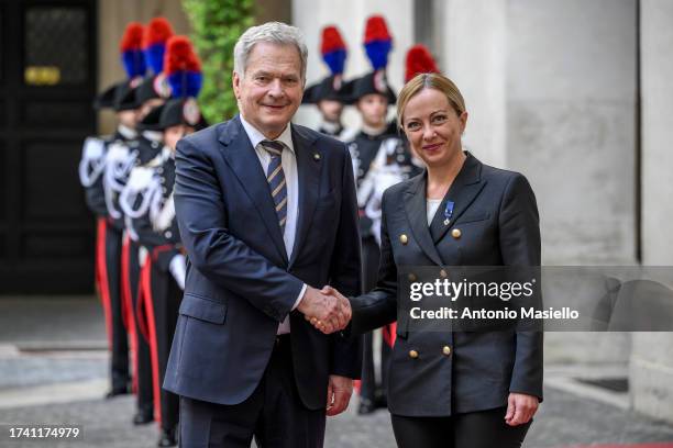 Finland's President Sauli Niinisto and Italian Prime Minister Giorgia Meloni shake hands before their meeting at Palazzo Chigi, on October 23, 2023...