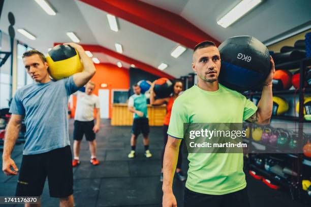 group of people exercising medicine ball lunges - medicine ball stock pictures, royalty-free photos & images