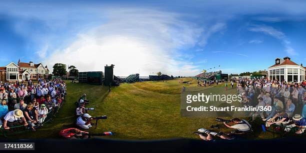Lee Westwood of England and Tiger Woods of the United States putt on the 18th green as galleries of spectators look on during the third round of the...