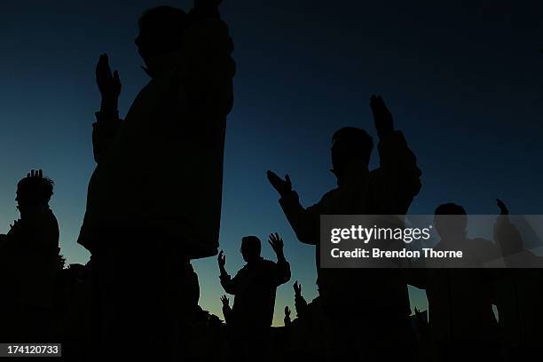 Falun Gong Practitioners meditate on the 14th anniversary of the beginning of the persecution of Falun Gong in China on July 21, 2013 in Sydney,...