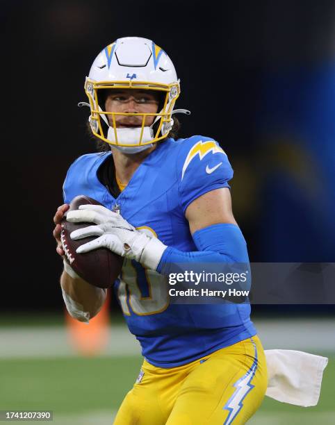Justin Herbert of the Los Angeles Chargers looks down field during a 20-17 loss to the Dallas Cowboys at SoFi Stadium on October 16, 2023 in...