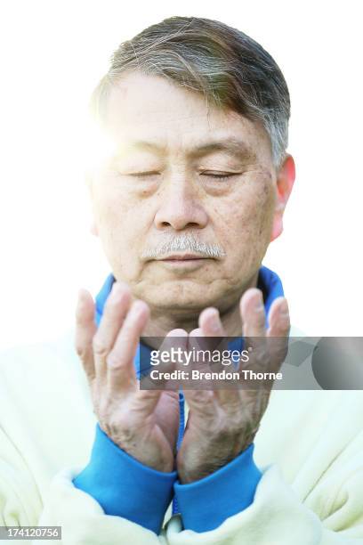 Falun Gong Practitioner poses on the 14th anniversary of the beginning of the persecution of Falun Gong in China on July 21, 2013 in Sydney,...