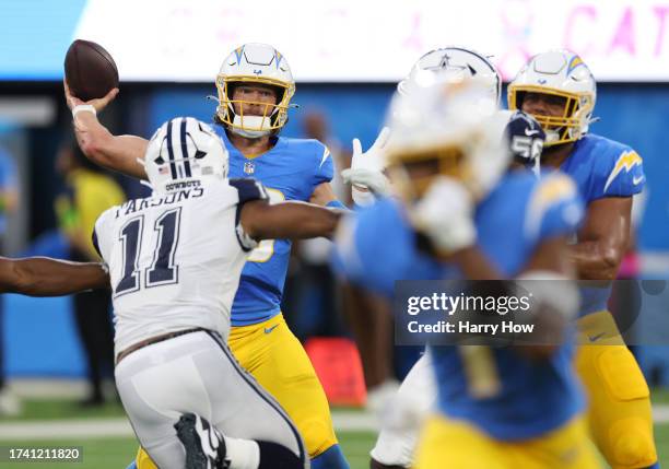 Justin Herbert of the Los Angeles Chargers passes in front of Micah Parsons of the Dallas Cowboys during a 20-17 loss to the Cowboys at SoFi Stadium...