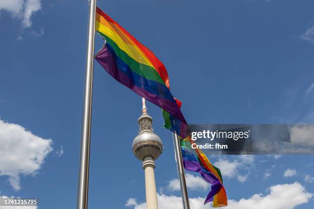 rainbow flags with berlin television tower (fernsehturm, germany) - berlin gay pride stock pictures, royalty-free photos & images