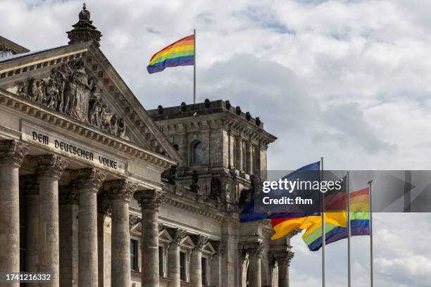 deutscher bundestag - the reichstag building with eu-, german- and lgbt+ - flags (german parliament building) - berlin, germany - berlin gay pride stock pictures, royalty-free photos & images